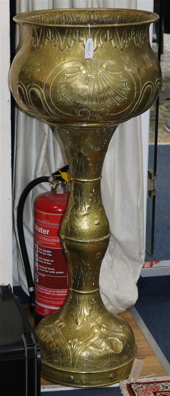 An early 20th century Dutch embossed brass jardiniere on stand